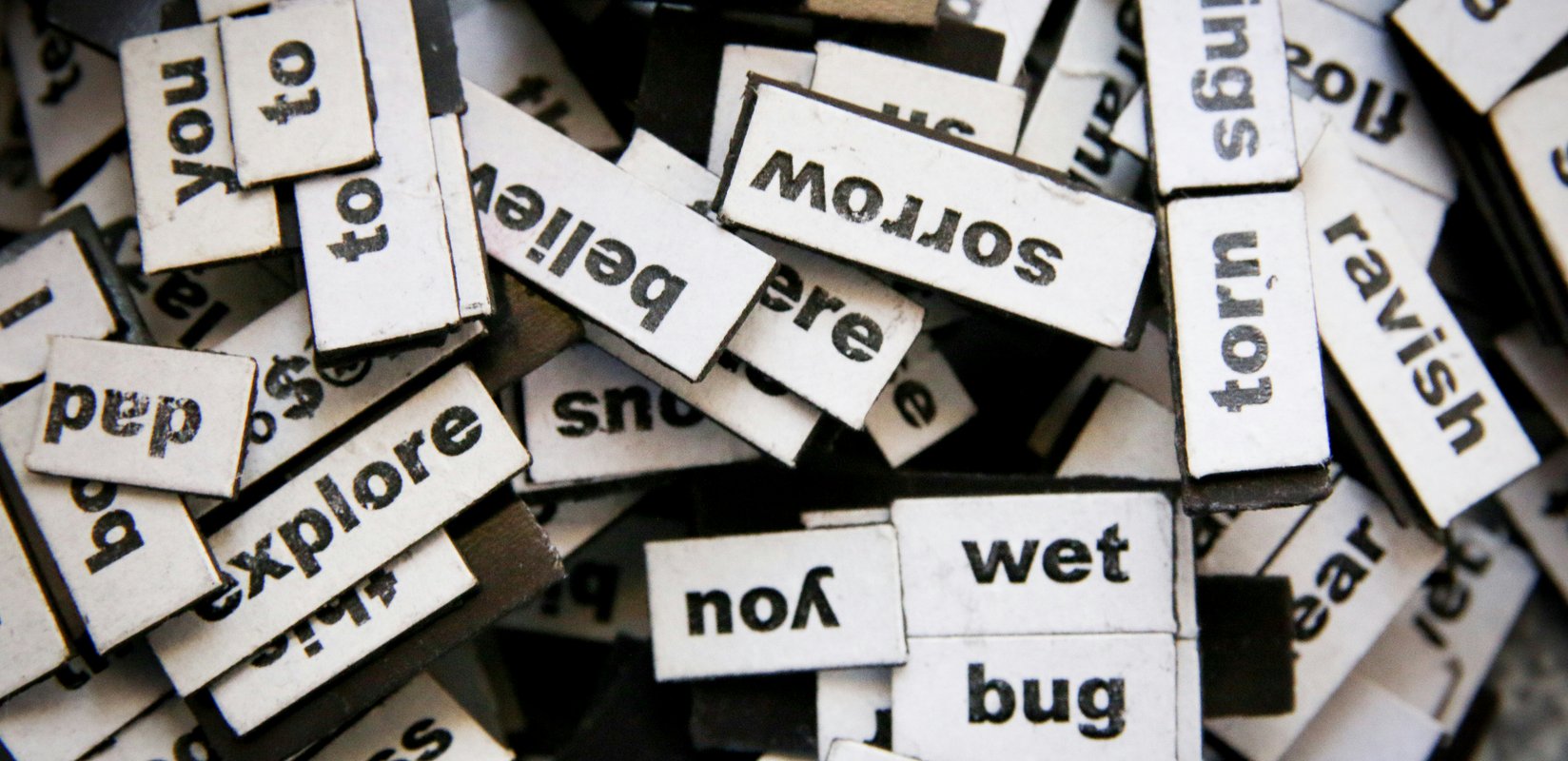 a jumbled pile of magnetic poetry words